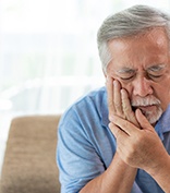 Man sitting on chair with toothache