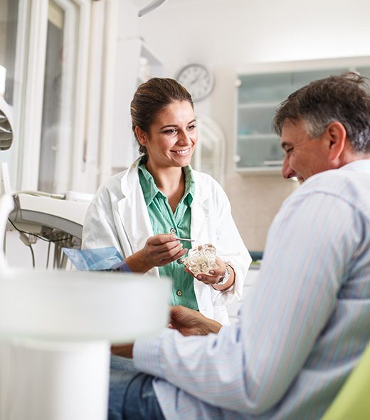 Dentist explaining treatment to smiling patient