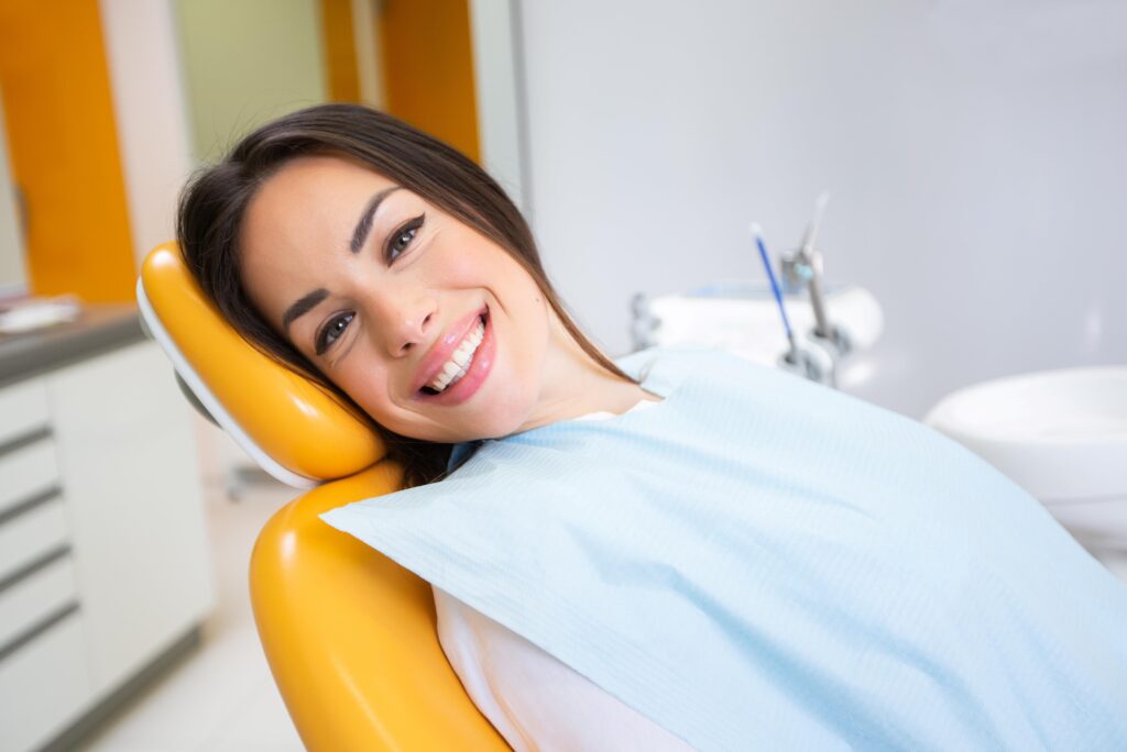 Woman smiling while sitting in treatment chair